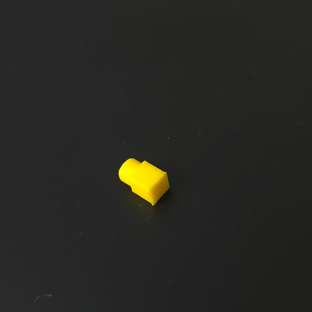Small yellow pin on a black background